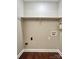 Empty laundry room featuring hardwood floors, shelf, and all connections needed for your appliances at 7401 Kinsmore Ln, Charlotte, NC 28269