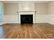Open living area features a stately fireplace, beautiful floors and plenty of room for entertaining at 7401 Kinsmore Ln, Charlotte, NC 28269