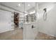 Bathroom with a vanity, large mirror, and a tiled shower at 8107 Houser St, Cornelius, NC 28031