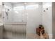 Bathroom with a white-tiled shower, shower bench, and rain-style showerhead at 8107 Houser St, Cornelius, NC 28031