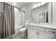 Bathroom featuring shower-tub combination with gray curtain and a vanity at 8107 Houser St, Cornelius, NC 28031