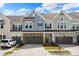 Charming townhome exterior featuring multi-tone facade, stone accents, and attached two-car garages at 8107 Houser St, Cornelius, NC 28031