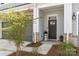 Inviting front porch with decorative columns, stone accents, and a charming entrance at 8107 Houser St, Cornelius, NC 28031