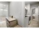 Hallway with a laundry room on one side and a vanity on the other at 8107 Houser St, Cornelius, NC 28031