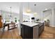 Bright kitchen featuring stainless steel appliances, an island with sink, and open layout to the living area at 8107 Houser St, Cornelius, NC 28031
