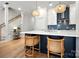 Contemporary kitchen featuring island seating, contrasting cabinets, and designer light fixtures at 8107 Houser St, Cornelius, NC 28031