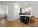 Modern kitchen featuring a large center island, stainless steel appliances, and sleek cabinetry at 8107 Houser St, Cornelius, NC 28031