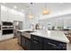 Modern kitchen with stainless steel appliances, white cabinets, and an island with a farmhouse sink at 8107 Houser St, Cornelius, NC 28031