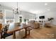 Open-concept living and dining area with natural light, modern furnishings, and hardwood floors at 8107 Houser St, Cornelius, NC 28031