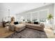 Bright living room featuring a plush sectional sofa, large windows, and a view of the dining area at 8107 Houser St, Cornelius, NC 28031