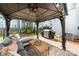Cozy outdoor patio under a gazebo features comfortable seating and a grill at 8107 Houser St, Cornelius, NC 28031