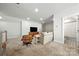 Spacious recreation room with TV, modern furniture, and adjoining bathroom with patterned tile at 8107 Houser St, Cornelius, NC 28031