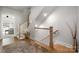 Well-lit stairway with wooden stairs, white railings, and stylish decor, creating an inviting and elegant transition space at 8107 Houser St, Cornelius, NC 28031