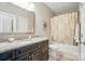 Bathroom featuring a marble countertop, wood cabinets, and a shower with a patterned curtain at 8473 Bing Cherry Dr, Denver, NC 28037
