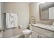 Cozy bathroom featuring a granite-topped vanity with neutral paint and decorative window at 8473 Bing Cherry Dr, Denver, NC 28037