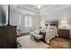 Comfortable bedroom features a large bed, stylish furniture and neutral tones for a relaxing retreat at 8473 Bing Cherry Dr, Denver, NC 28037