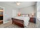 Neutral bedroom featuring a ceiling fan, bedside tables with lamps, and a decorative area rug at 8473 Bing Cherry Dr, Denver, NC 28037