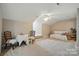 Bright bonus room with neutral paint, carpet, a ceiling fan, and furniture at 8473 Bing Cherry Dr, Denver, NC 28037