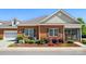 Well maintained brick home featuring manicured landscaping and a screened-in porch at 8473 Bing Cherry Dr, Denver, NC 28037