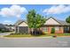 Beautiful single-story brick home with a screened porch, landscaping, and a tree-lined street at 8473 Bing Cherry Dr, Denver, NC 28037