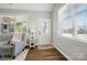 Welcoming foyer featuring hardwood floors, a glass front door, and an accent chair at 8473 Bing Cherry Dr, Denver, NC 28037