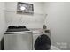 Laundry room featuring a modern washer and dryer set and a wire shelf for storage at 8473 Bing Cherry Dr, Denver, NC 28037