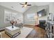 Cozy living room with hardwood floors, a fireplace, and a vaulted ceiling at 8473 Bing Cherry Dr, Denver, NC 28037