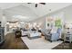 Bright living room features hardwood floors, a tray ceiling, and a view into the kitchen at 8473 Bing Cherry Dr, Denver, NC 28037