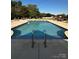 Sparkling community pool with lounge chairs and tables for relaxing on a sunny day at 8473 Bing Cherry Dr, Denver, NC 28037