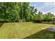 Well-maintained backyard includes a shed and lush greenery, enclosed by a black metal fence at 10417 Ebbets Rd, Charlotte, NC 28273