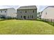 Wide backyard view with a well-kept lawn, fenced perimeter, and a clear view of the home's rear at 10417 Ebbets Rd, Charlotte, NC 28273