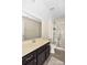 Bathroom featuring a vanity with a sink, large mirror, and a shower with glass doors at 10417 Ebbets Rd, Charlotte, NC 28273