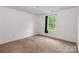 A bright bedroom with a large window letting in plenty of natural light at 10417 Ebbets Rd, Charlotte, NC 28273