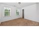 A light-filled bedroom with two windows and a neutral color scheme at 10417 Ebbets Rd, Charlotte, NC 28273