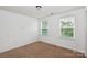 Bedroom featuring a neutral color scheme, natural lighting, and carpeted floors at 10417 Ebbets Rd, Charlotte, NC 28273