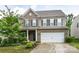 Two-story home displays brick and siding, a two-car garage, and landscaped front yard at 10417 Ebbets Rd, Charlotte, NC 28273