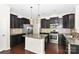 Well-equipped kitchen features stainless appliances, granite counters, and rich wood flooring at 10417 Ebbets Rd, Charlotte, NC 28273