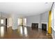 Large living room showcasing hardwood floors, fireplace, and an archway to another room at 10417 Ebbets Rd, Charlotte, NC 28273