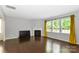 Spacious living room with fireplace, hardwood floors, and many sunny windows at 10417 Ebbets Rd, Charlotte, NC 28273