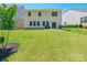 Large, level backyard with well-maintained lawn and patio, perfect for outdoor entertaining and activities at 115 Haddonsfield Dr, Mooresville, NC 28115