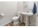 Elegant powder room featuring a pedestal sink and modern fixtures at 115 Haddonsfield Dr, Mooresville, NC 28115