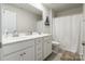 Bright bathroom featuring a double vanity, neutral color palette, and shower with a white curtain at 115 Haddonsfield Dr, Mooresville, NC 28115