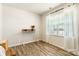 Bright bedroom features wood-look flooring, large window, and stylish desk with decor at 115 Haddonsfield Dr, Mooresville, NC 28115