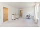 Bright, carpeted bedroom with neutral walls, and a desk area with a comfortable chair at 115 Haddonsfield Dr, Mooresville, NC 28115