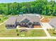 Aerial view of the clubhouse featuring manicured landscaping, a community pool, and walking paths at 115 Haddonsfield Dr, Mooresville, NC 28115