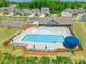 Aerial view of the community pool surrounded by lounge chairs, umbrellas, and landscaped areas in a desirable neighborhood at 115 Haddonsfield Dr, Mooresville, NC 28115