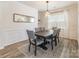 Elegant dining room features modern light fixture, decorative mirror, and sleek table with six chairs at 115 Haddonsfield Dr, Mooresville, NC 28115