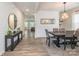 Elegant dining room featuring modern chandelier, sleek table with six chairs, and wood-look flooring at 115 Haddonsfield Dr, Mooresville, NC 28115
