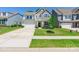 Charming two-story home boasts stone accents, manicured lawn, and attached two car garage at 115 Haddonsfield Dr, Mooresville, NC 28115