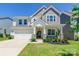 Charming two-story home with stone accents, a welcoming front porch, and manicured landscaping at 115 Haddonsfield Dr, Mooresville, NC 28115